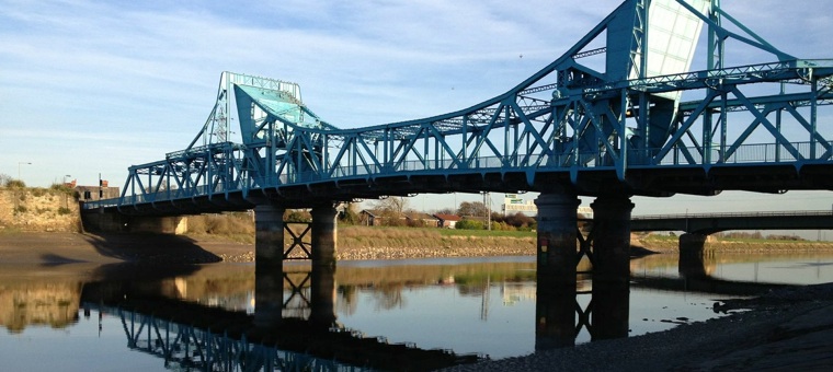 Blue steel bridge across river Dee in Sealand